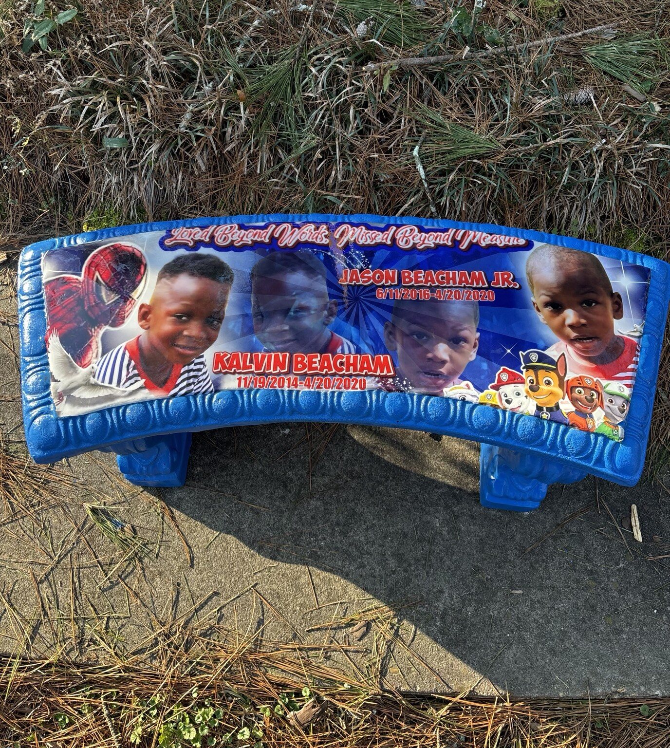 Custom blue children’s memorial bench with portraits and tribute artwork